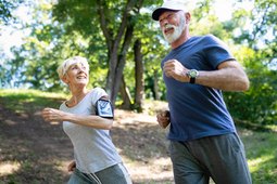 Older woman and man running outside