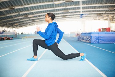 Young female athlete lunging
