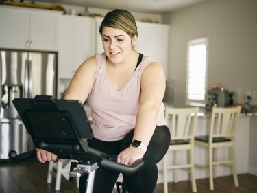 woman doing 20-minute stationary bike workout at home