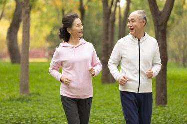 senior chinese couple jogging in the park