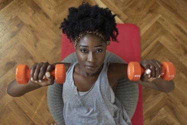 Woman doing a dumbbell chest press during an at-home workout