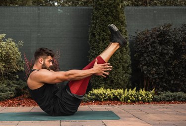 fit man doing a 20-minute pilates workout outdoors